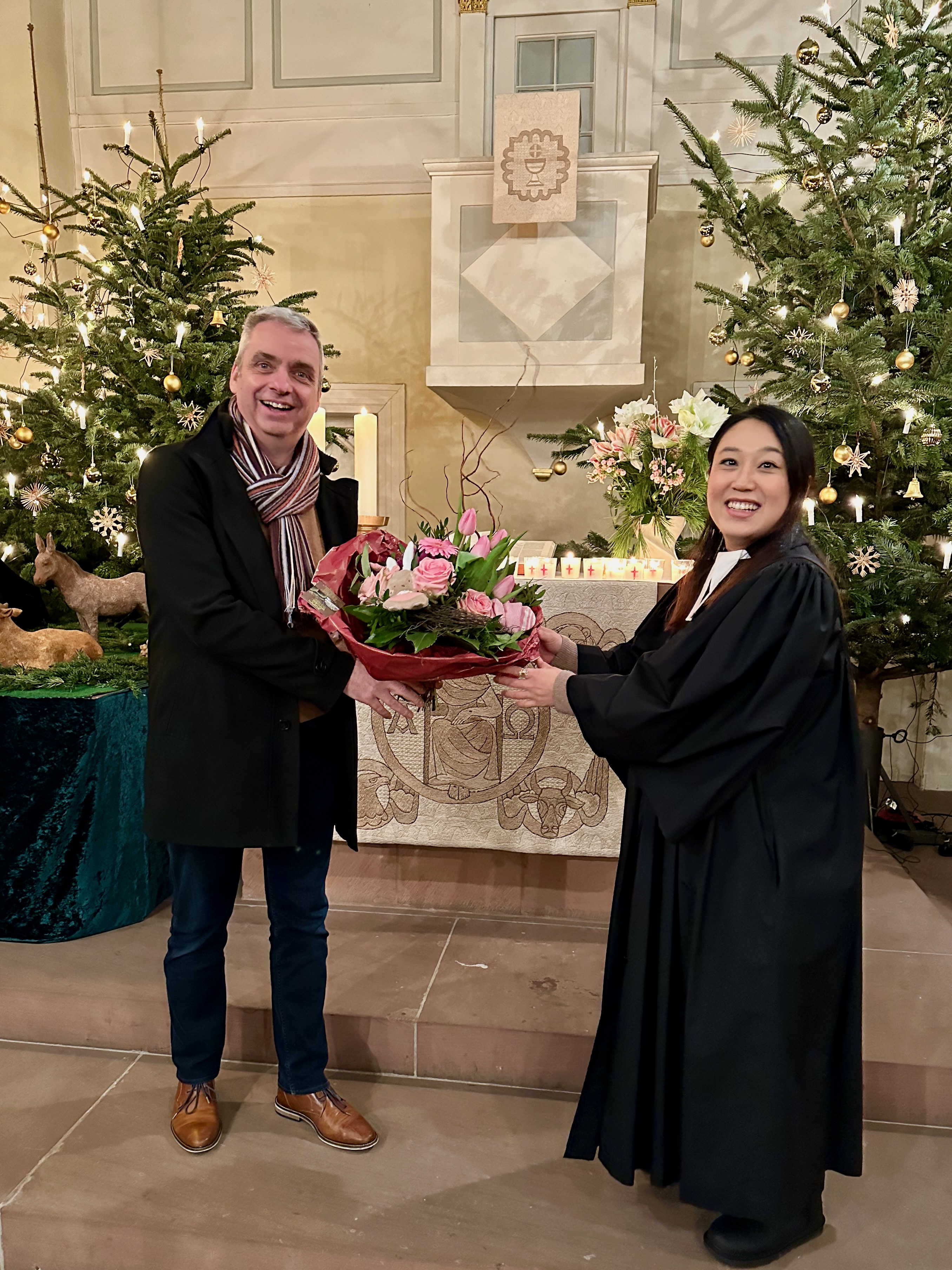 Pfarrerin Helen Lee bekommt nach dem Gottesdienst in der St. Martinskirche einen Blumenstrauß von Kirchenvorstand Carsten Höfer überreicht.